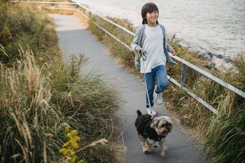 Happy little boy running with puppy