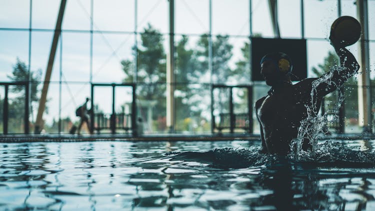 Man Throwing A Ball While Playing Water Polo