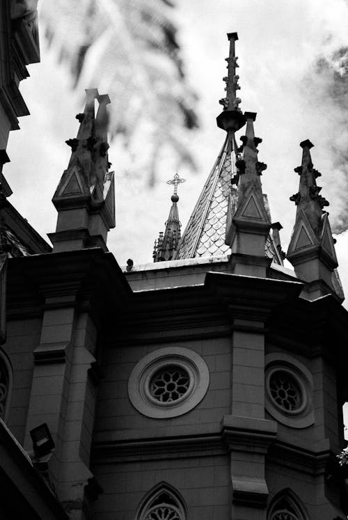 Free Old cathedral with cross and spires on roof Stock Photo