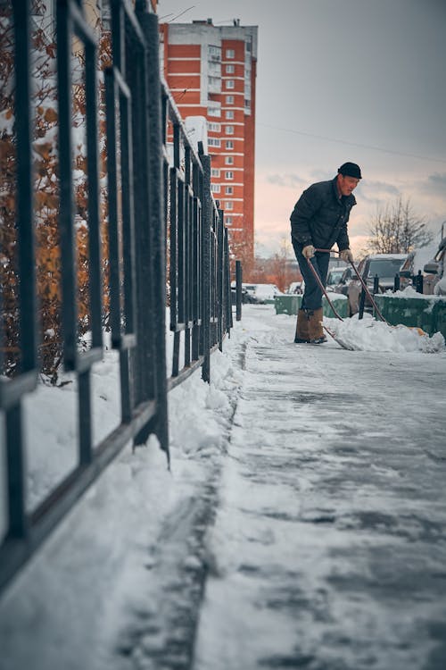 Man Shoveling the Snow of the Sidewalk