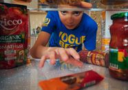 Boy in Blue Crew Neck T-shirt Grabbing a Snack