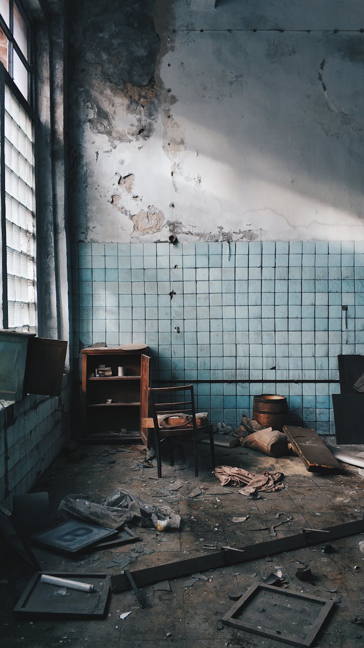 Old House With Damaged Furniture Near Weathered Wall