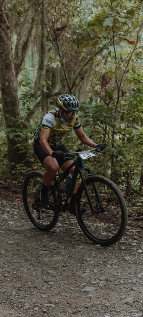 Man Riding a Bicycles on Dirt Road