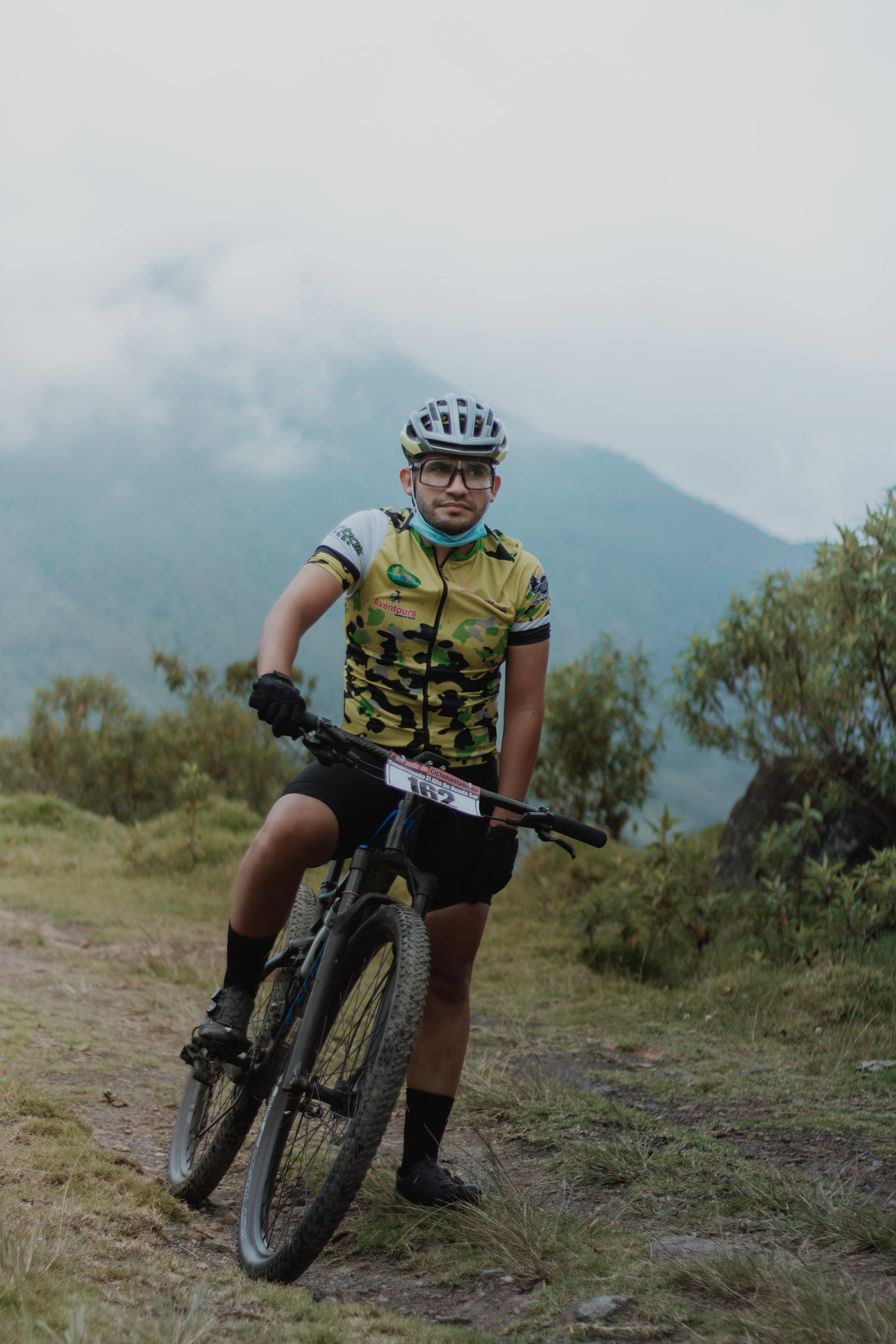 A cyclist navigates a foggy mountain trail, showcasing the spirit of adventure and outdoor sports.
