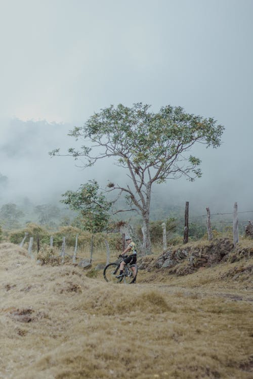 Man Riding a Bicycle on Dirt Road