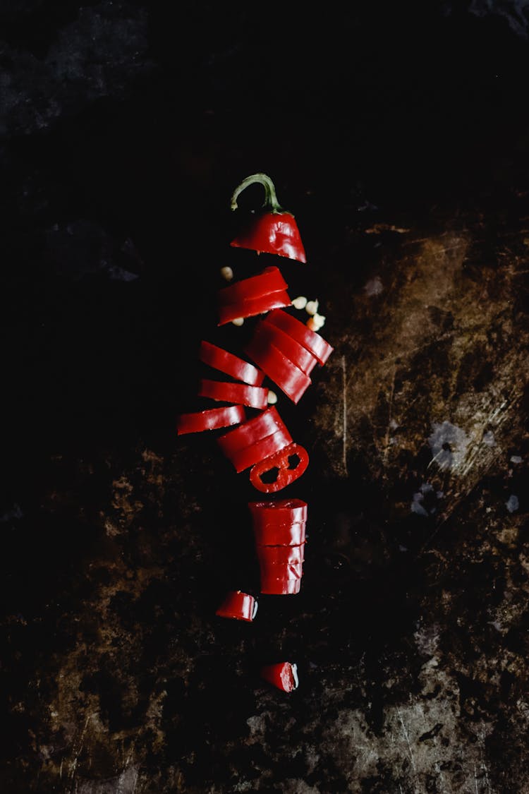 Sliced Red Chili Pepper On Brown Surface