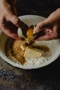A Person Cracking an Egg in the Bowl