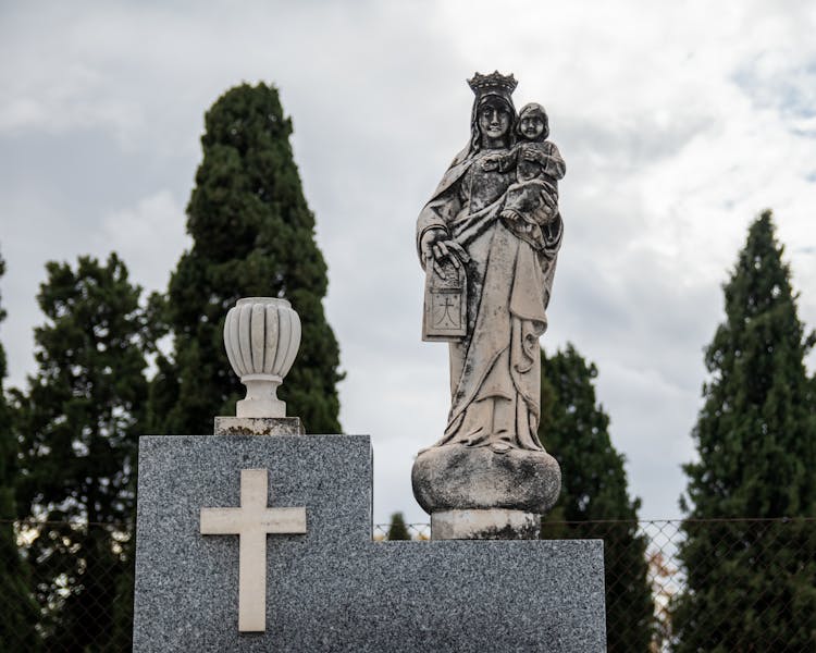 Statue Of Virgin Mary With Baby Jesus On A Tomb 