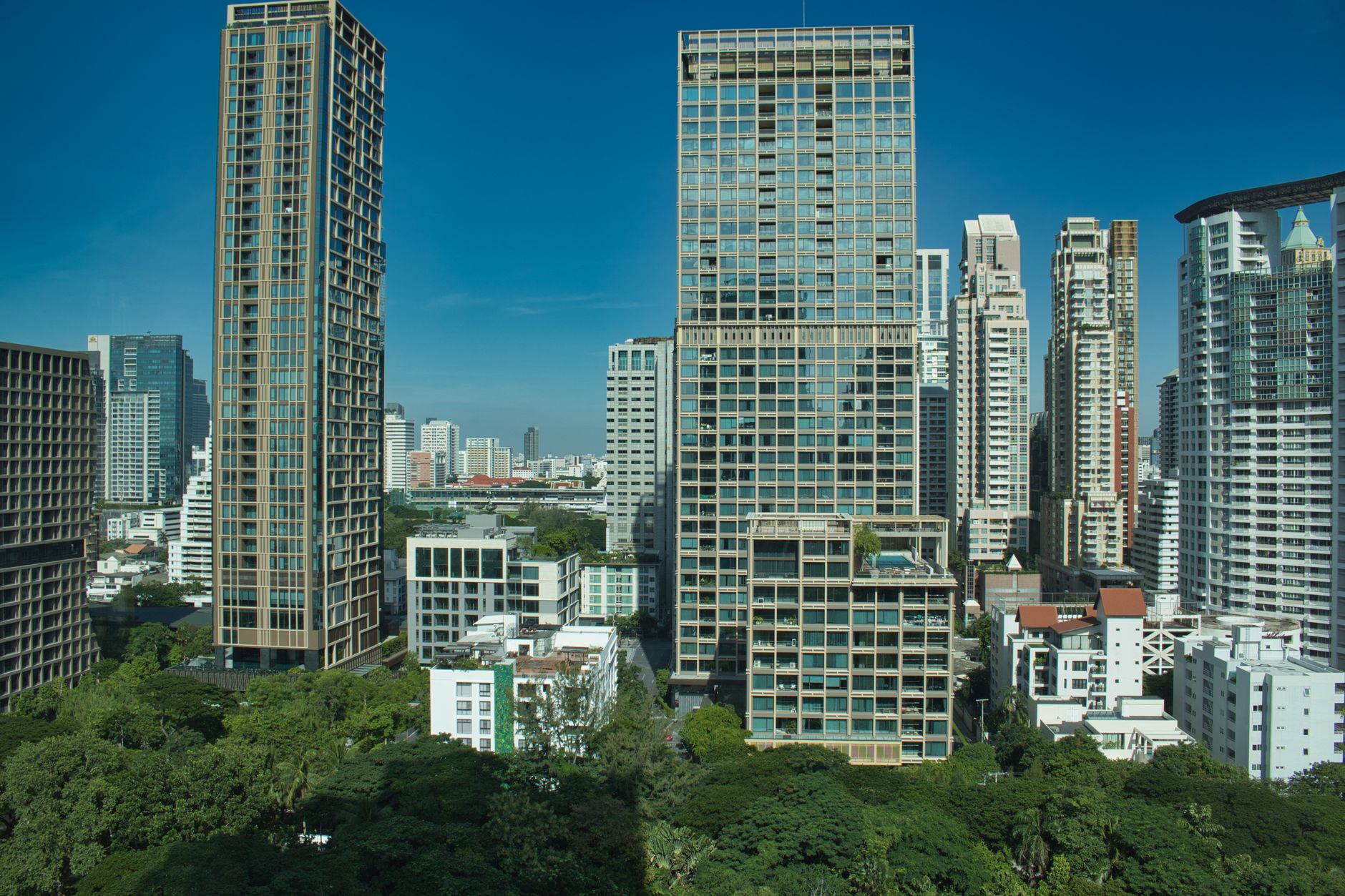 Ekkamai street with mid-rise condos and independent restaurants at dusk