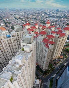 Aerial view of modern high-rise buildings in Jakarta, Indonesia, showcasing urban architecture.