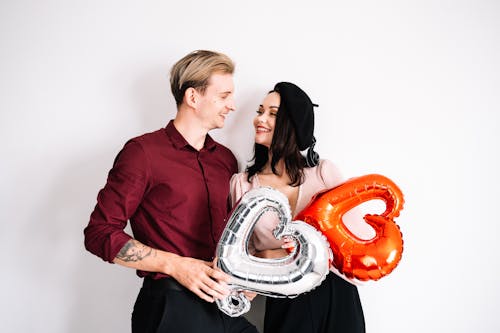 Free Couple Holding Heart Balloons Stock Photo