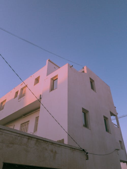 White Concrete Building Under the Blue Sky