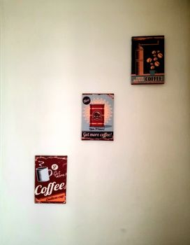 Minimalist interior with vintage coffee posters displayed on a simple wall.