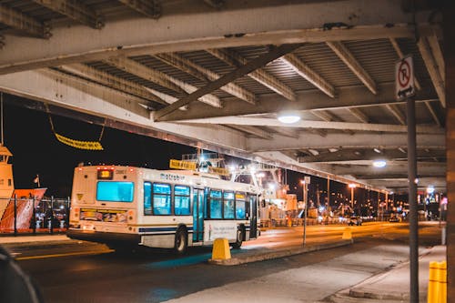 Free Bus driving on road at night Stock Photo