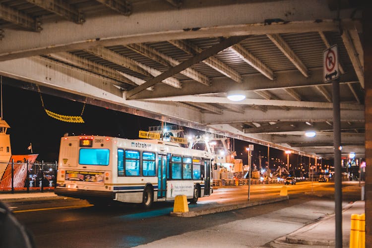 Bus Driving On Road At Night