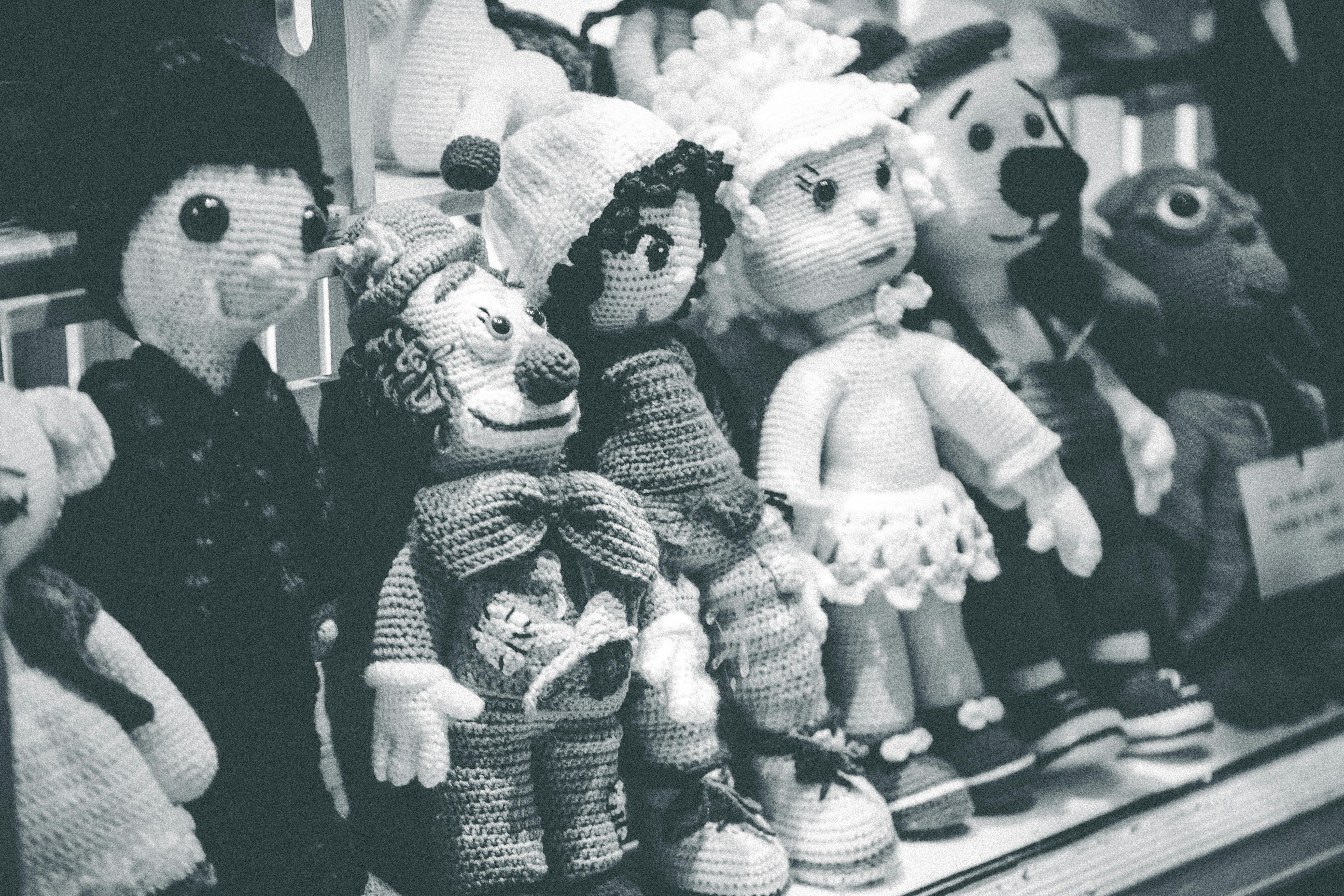 collection of various knitted toys in store