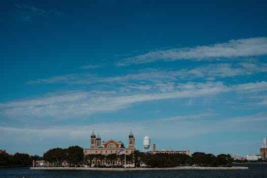 Stunning view of Ellis Island Immigration Museum against a bright blue sky.