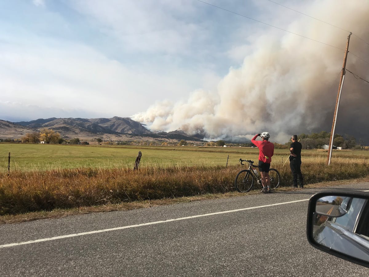 Raw chicken pieces in a bowl with spices and yogurt marinade being mixed with a spoon