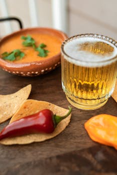 Delicious Mexican snack with nachos, salsa, and beer, perfect for parties.