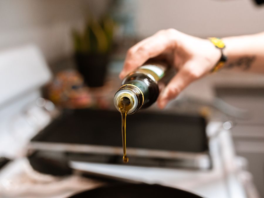 Refined cooking oil being poured from a bottle