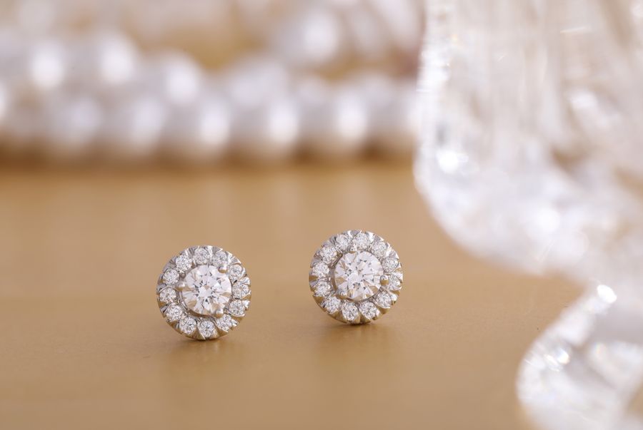 Round diamond earrings on a gold background