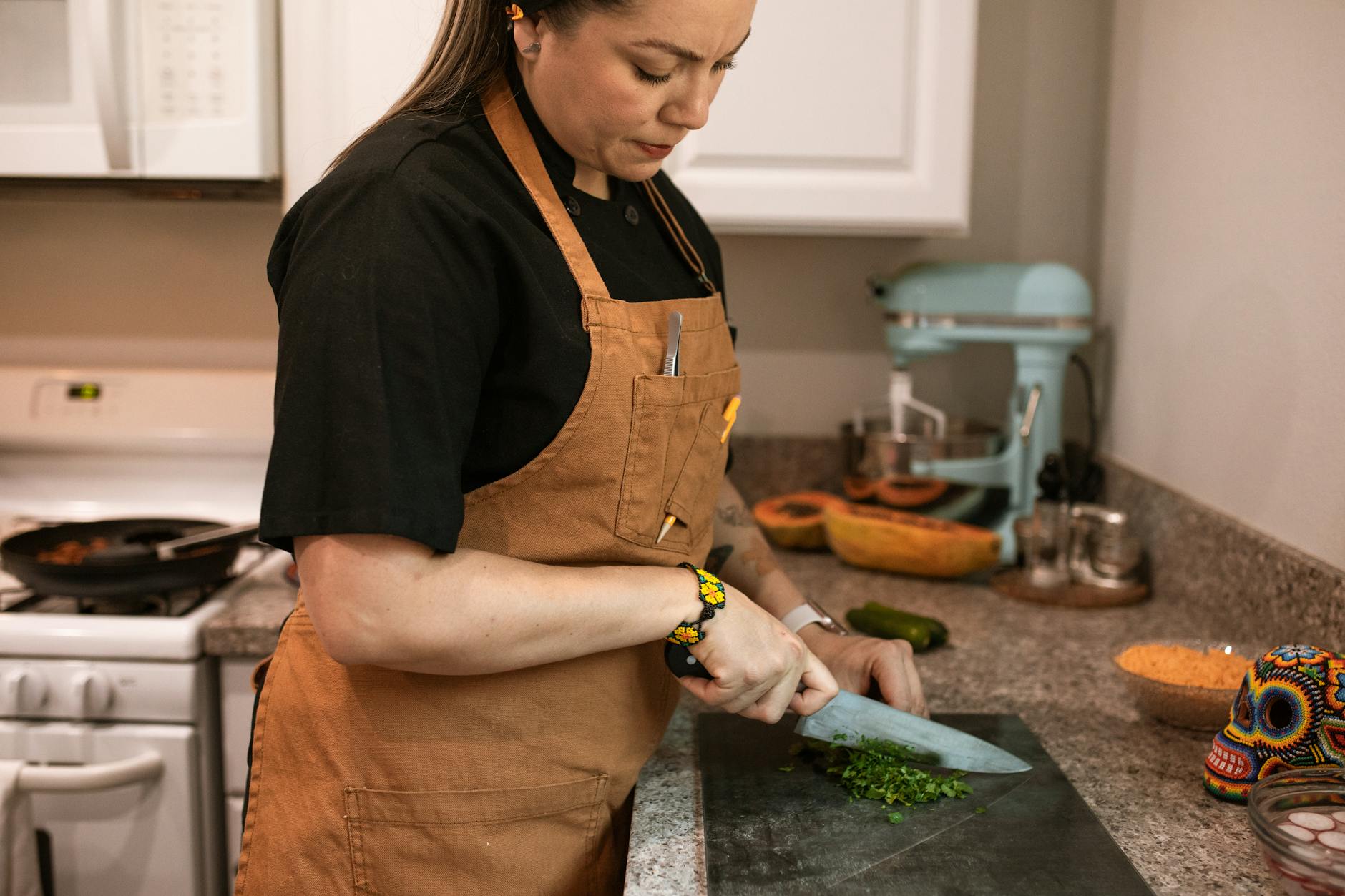 Handling Hot Surfaces and Foods https://www.pexels.com/photo/a-woman-chopping-green-vegetable-5737372/