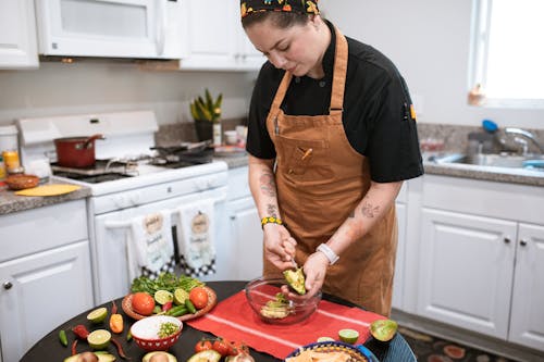 A Person Putting Avocado in the Bowl