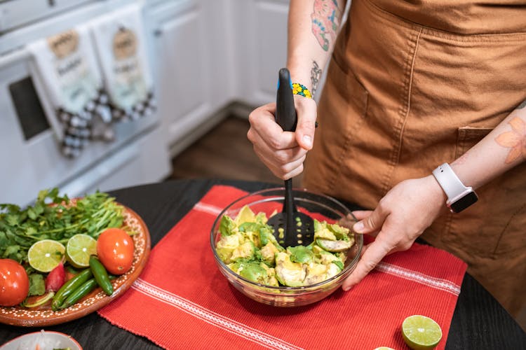 A Person Making Guacamole