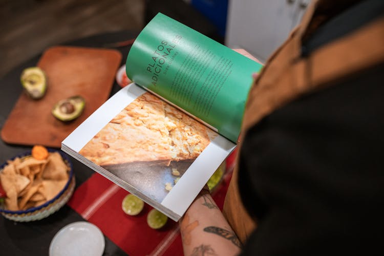 A Person Reading A Cookbook