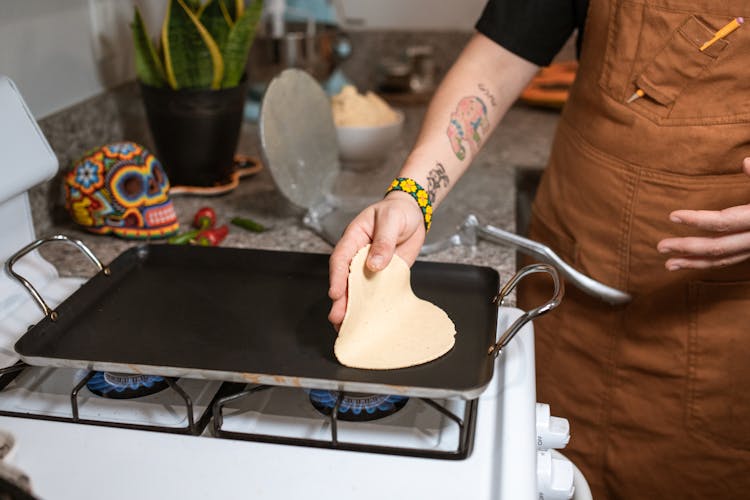 A Person Cooking In A Tray Pan