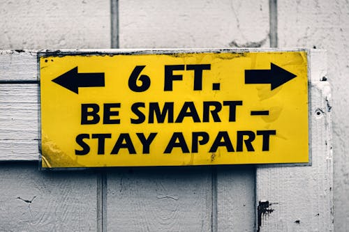 Yellow Warning Sign on Wooden Wall