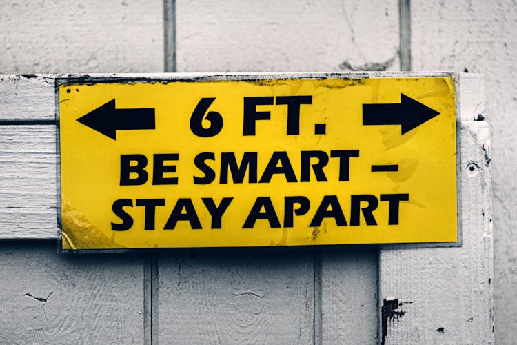 Yellow Warning Sign On Wooden Wall