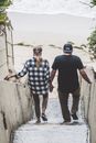 A Couple Walking Down the Concrete Steps with Hands Together
