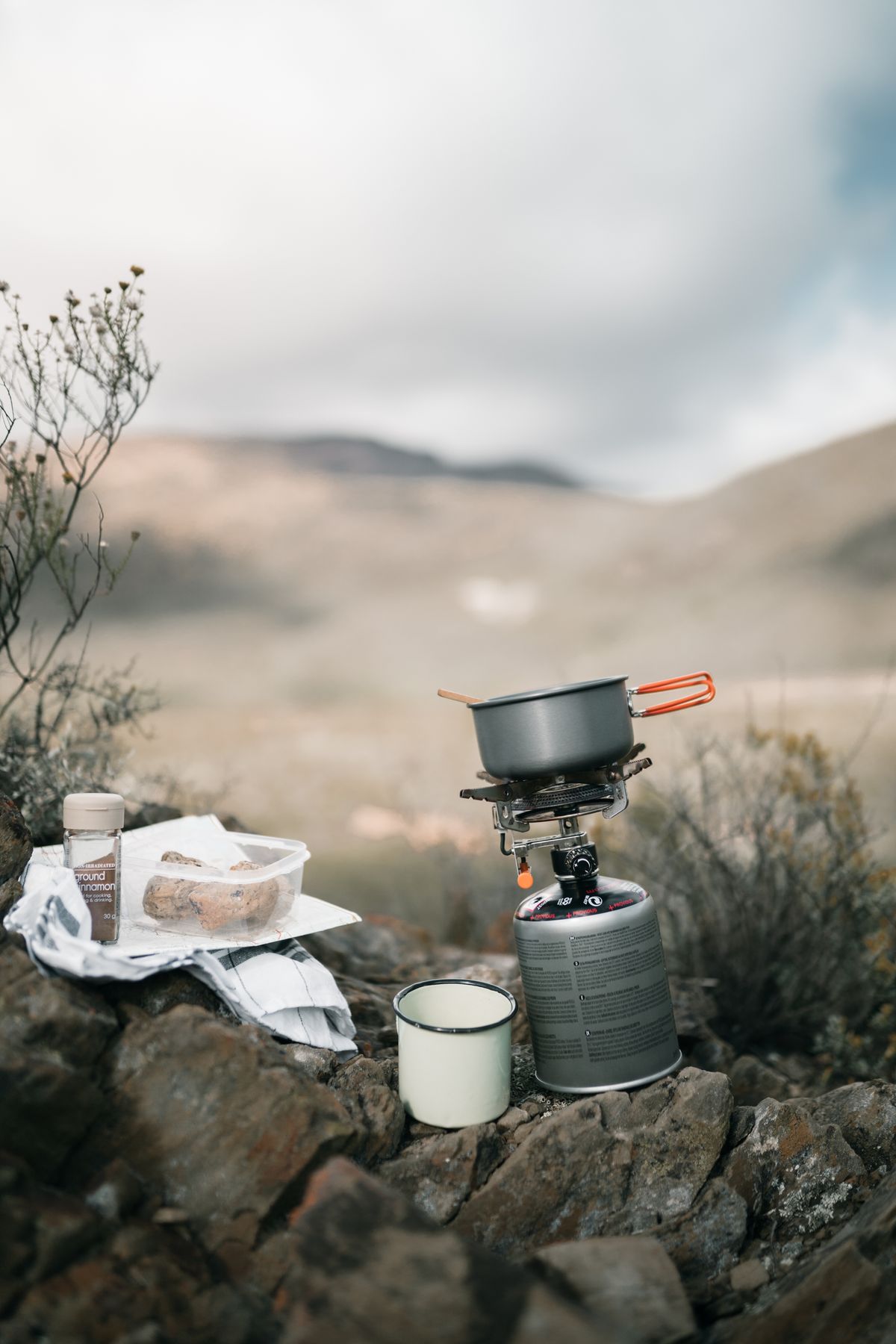 Portable camping stove and cookware in a mountain setting