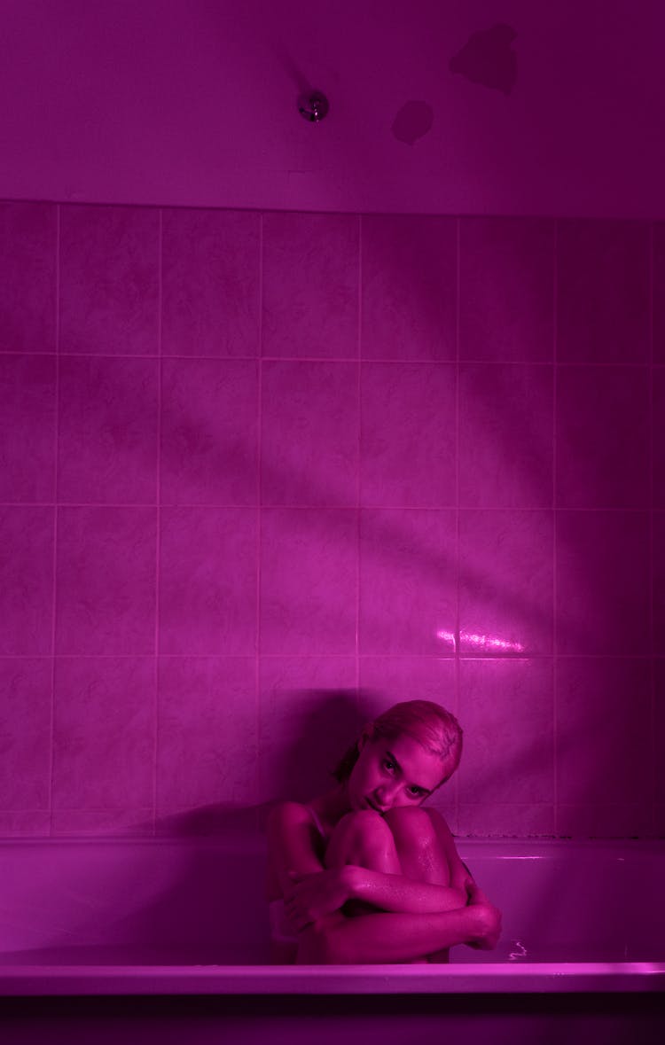 Sensual Woman In Bath With Neon Light