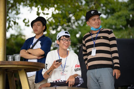 Three young men enjoying a casual day outdoors with smiles and camaraderie.