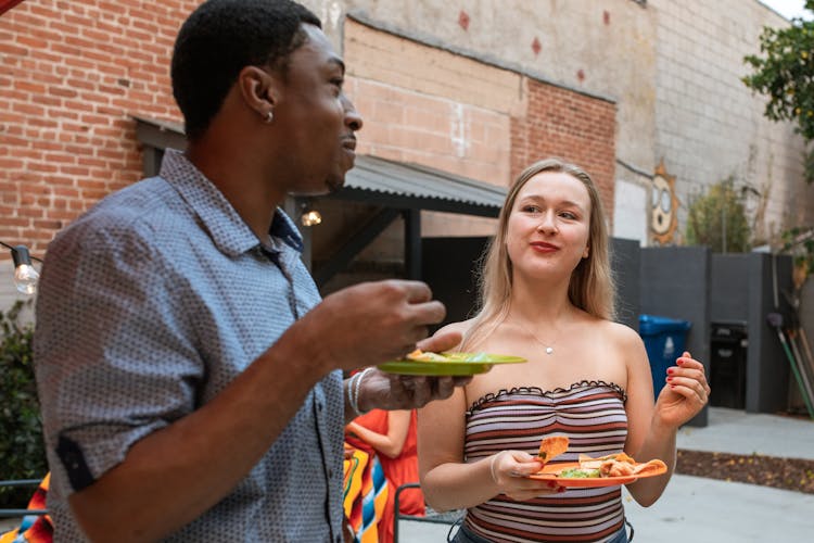 Man And Woman Eating Nachos