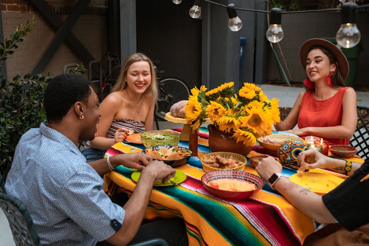 A People Eating While Talking Together 