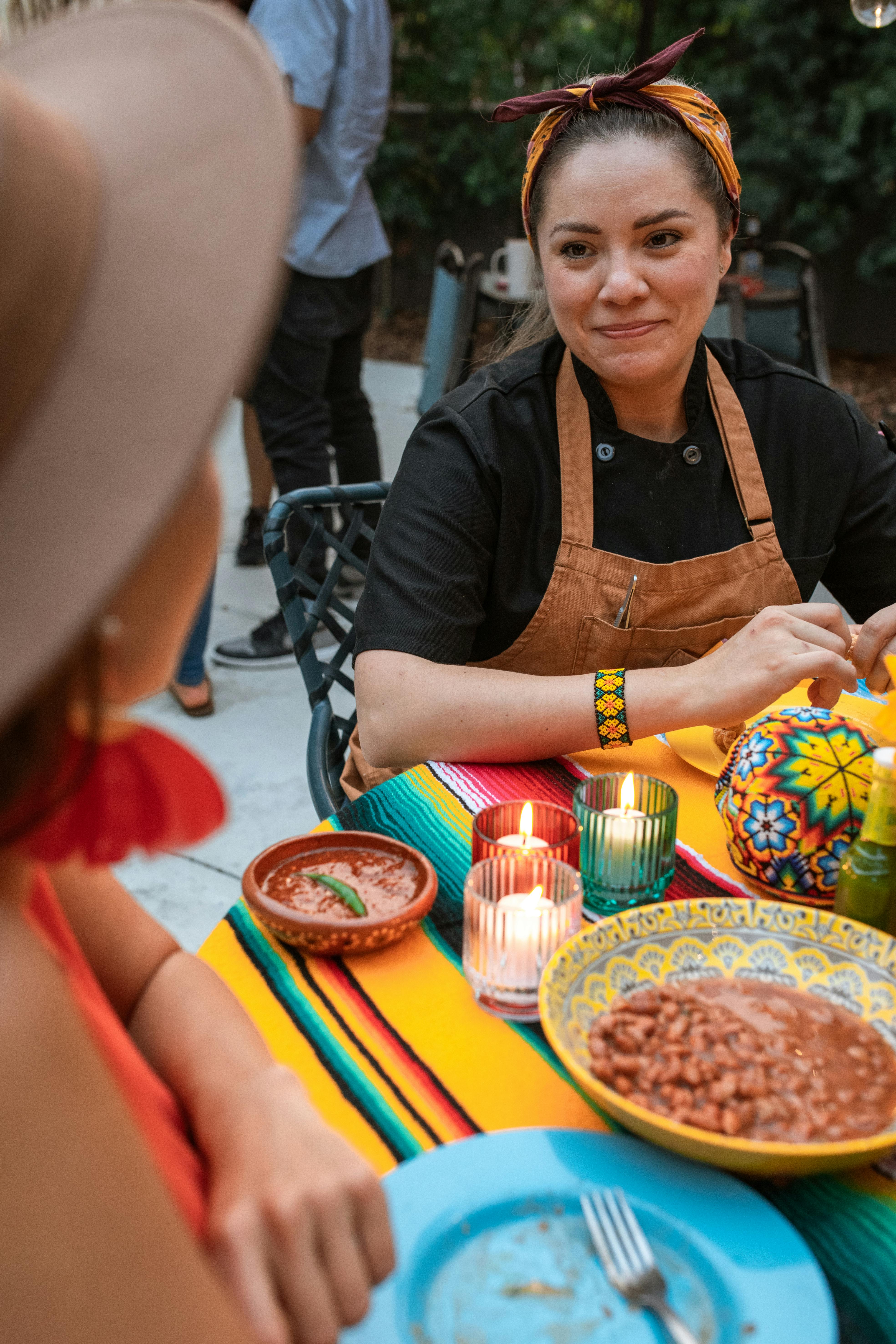 A vibrant outdoor dining scene showcasing Mexican cuisine and friendly interaction.