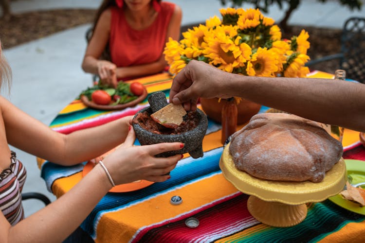 Crop Unrecognizable People Eating Meat Stew And Nachos