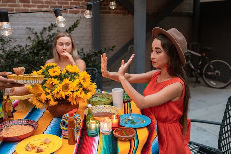 Friends Eating Dinner On A Terrace 