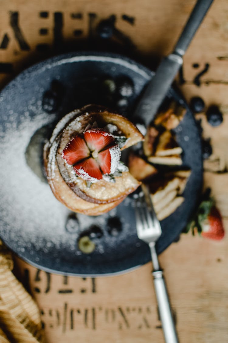 Overhead Shot Of A Strawberry On Top Of Pancakes