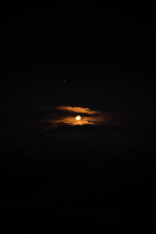 Moon Setting over the Clouds