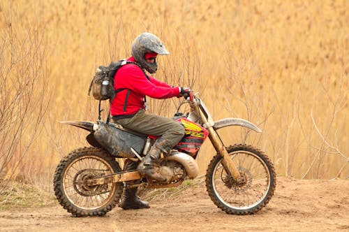 Free Man in Red Sweater Driving Dirt Bike Stock Photo