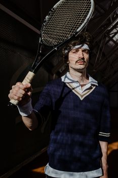 A retro-themed portrait of a mustached male tennis player holding a racket indoors.