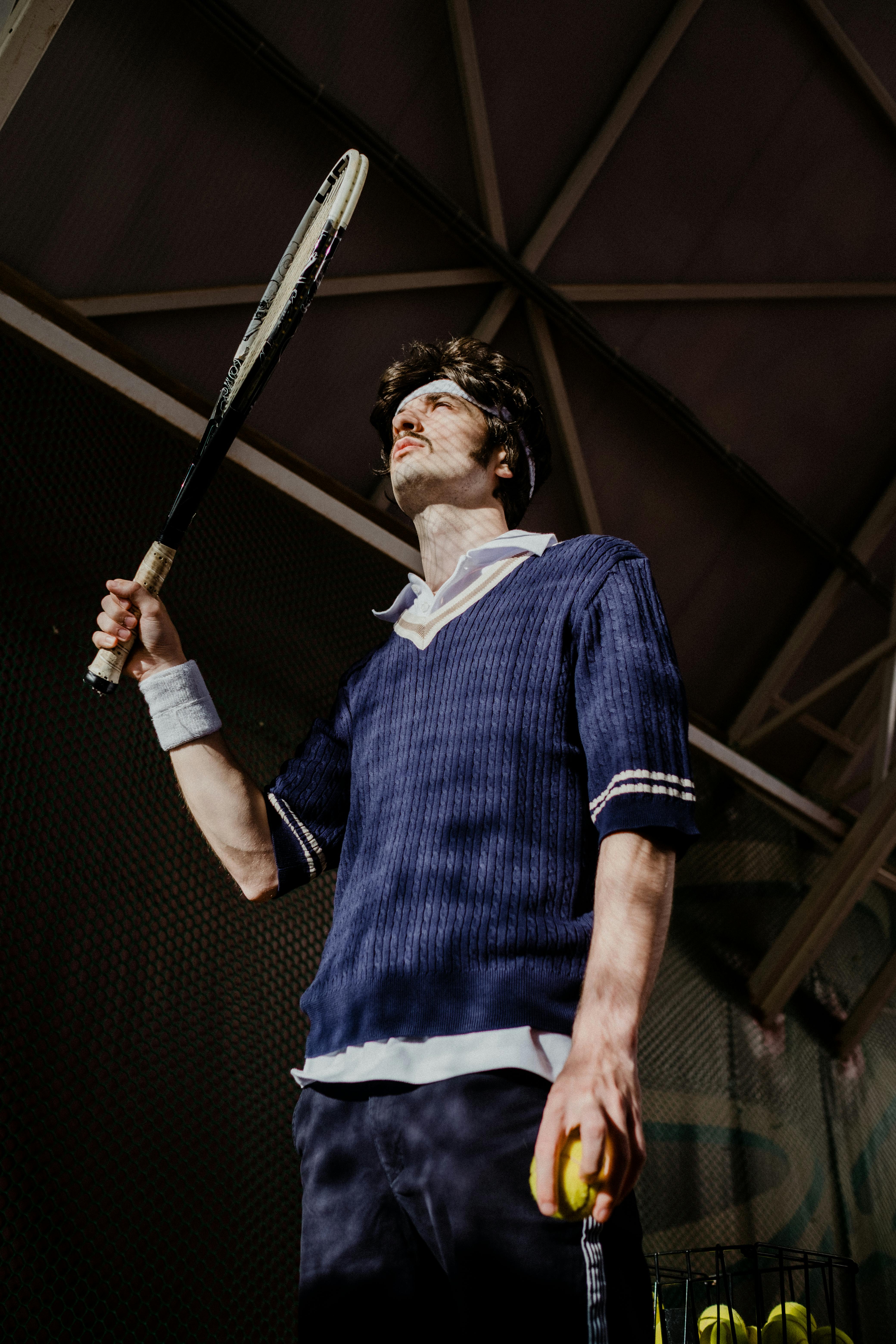 Female tennis player hitting a powerful forehand shot on a blue court