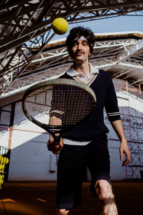 Woman in Black and White Shirt Holding Tennis Racket