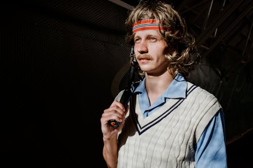 Man in White and Black Striped Dress Shirt Holding Microphone