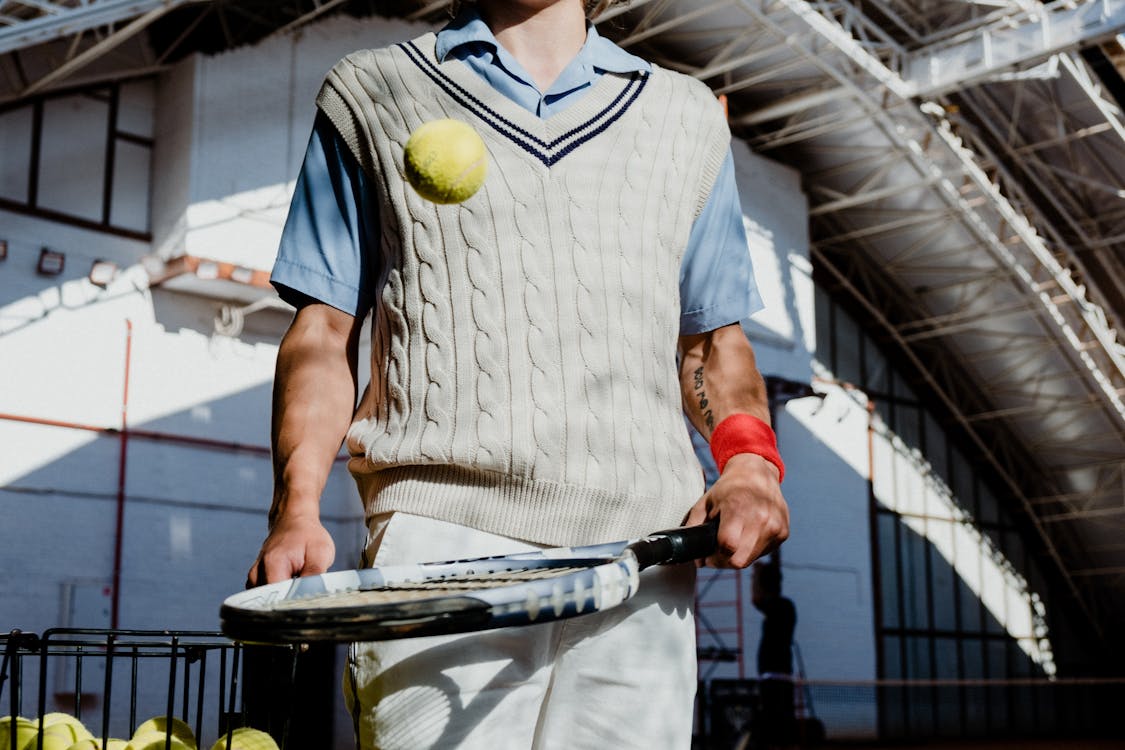 Man in White and Black Stripe Polo Shirt Holding Tennis Racket