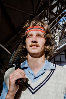 Portrait of a tennis player with a racquet and sweatband, styled in retro fashion.